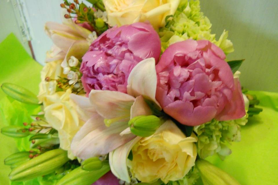 Bridal bouquet with peonies, lilies, roses, waxflower and hydrangea