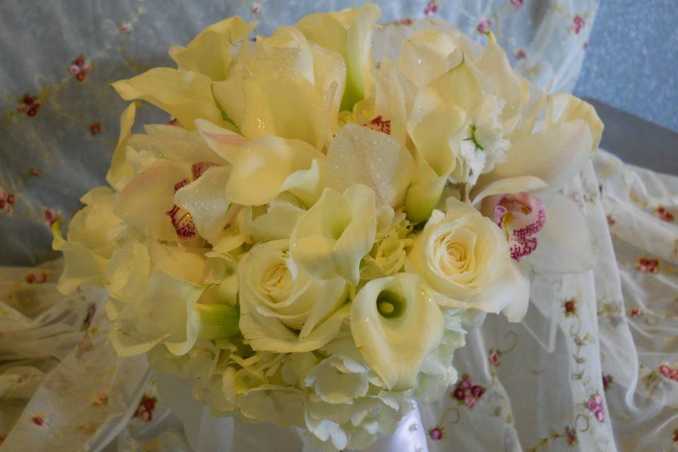 Bridal bouquet with roses, mini calla lilies, hydrangea, cymbidium orchids, lisianthus and white stock