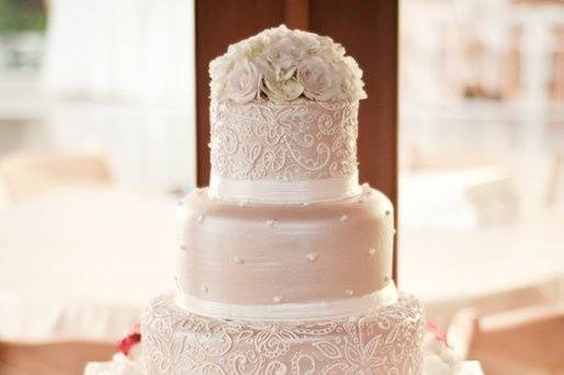 Intricate Lace piping covers this taupe colored buttercream cake.