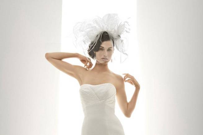 Moet- This elegant silk satin organza Matthew Christopher dress is intoxicating! The strapless empire bodice and full trumpet skirt are adorned with sculptural, multidirectional bias strips. A triple overlay flutters down the modified chapel-length train, completed by covered buttons all down the back.