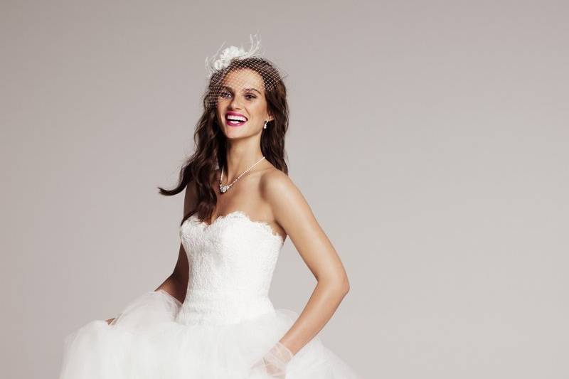 890013- This beautiful strapless Theia ball gown features a sweetheart lace bodice and tulle skirt to create a classic and fun look.