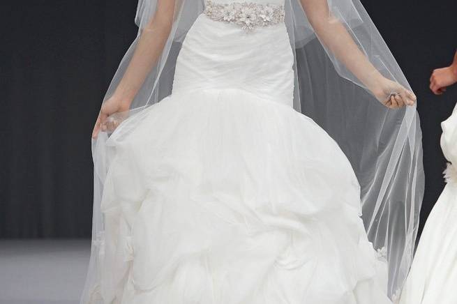 Amherst- A luxurious La Fleur by Anne Barge pearl gown with an elongated strapless bodice in shirred tulle that flows into an elegant pick-up skirt.