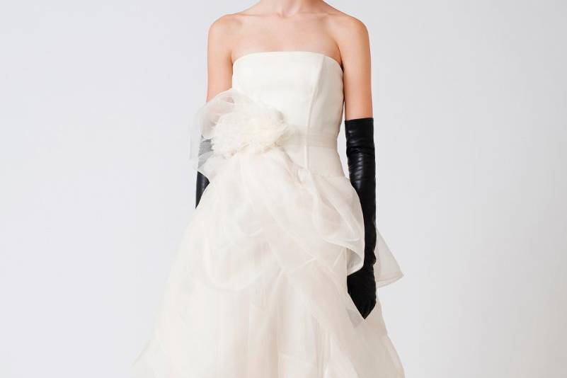 Erin-Exquisite, airy tissue organza, a delicately tucked, layered skirt and a flower corsage at the natural waist accent an ethereal, strapless Vera Wang ballgown.