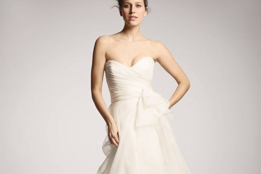 Nouvelle Amsale - R102G- This Amsale silk organza A-line ballgown features a ruched sweetheart neckline and a flowing skirt tucked in the back for a modern draping effect.