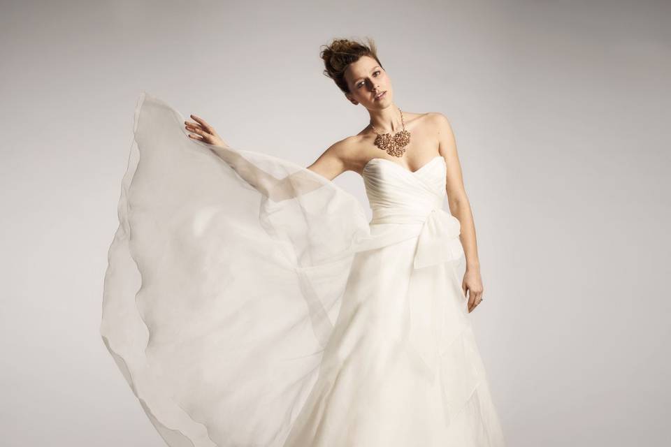 Nouvelle Amsale - R102G- This Amsale silk organza A-line ballgown features a ruched sweetheart neckline and a flowing skirt tucked in the back for a modern draping effect.