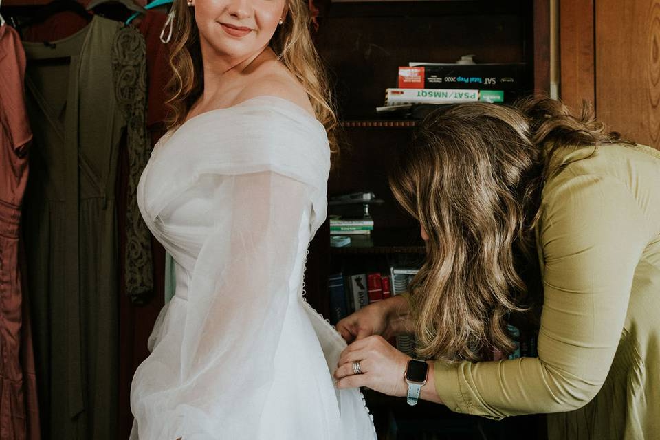 Bride Putting on Dress