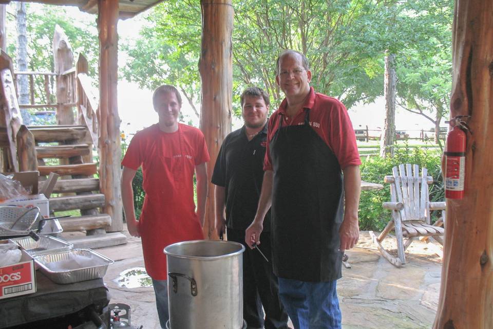 Catering team beside a cauldron