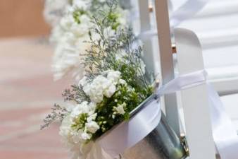 Aluminum pots with garden style flowers lining the aisle for a March garden ceremony