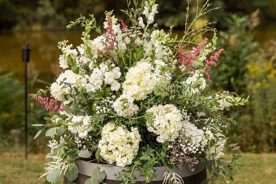 Ceremony flowers atop barrels