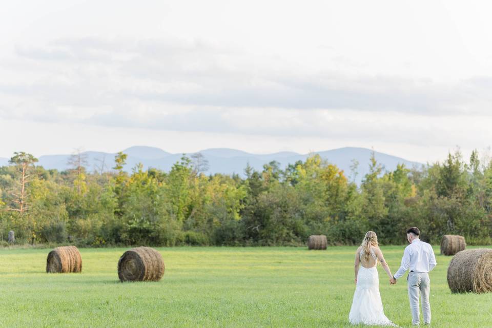 Bride and groom in field.