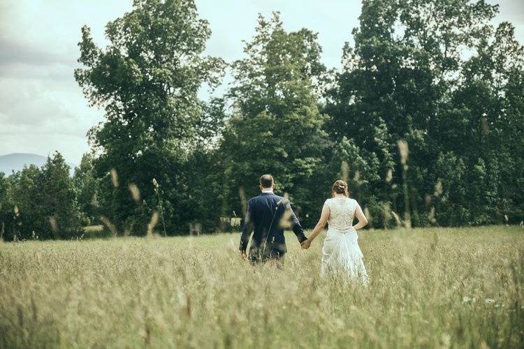 Bride and groom in field.