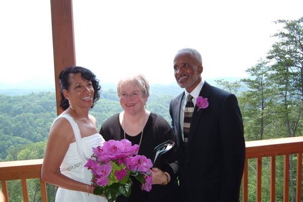 The newlyweds with the wedding officiant