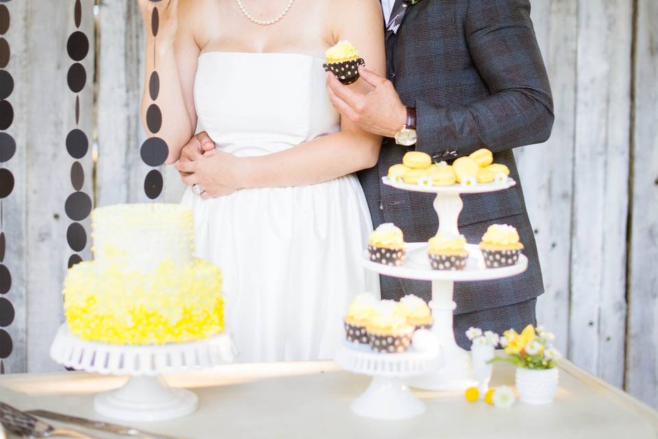 Couple laugh and smile by the cake
