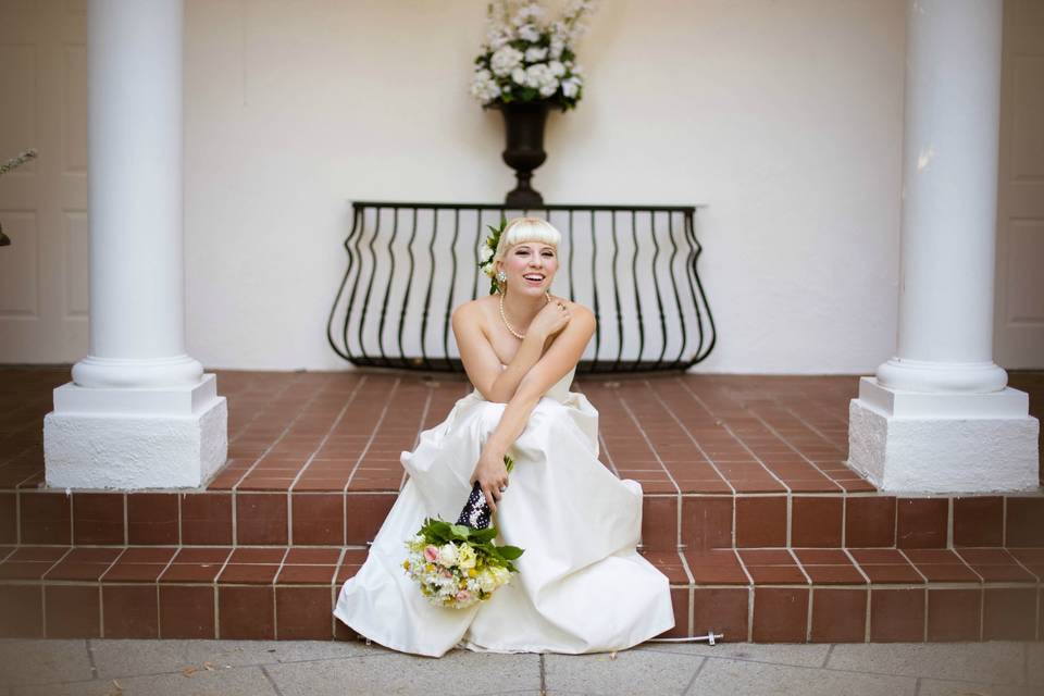 Posing in white gown on red stairs