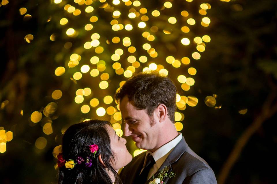 Couple portrait in front of twinkle lights