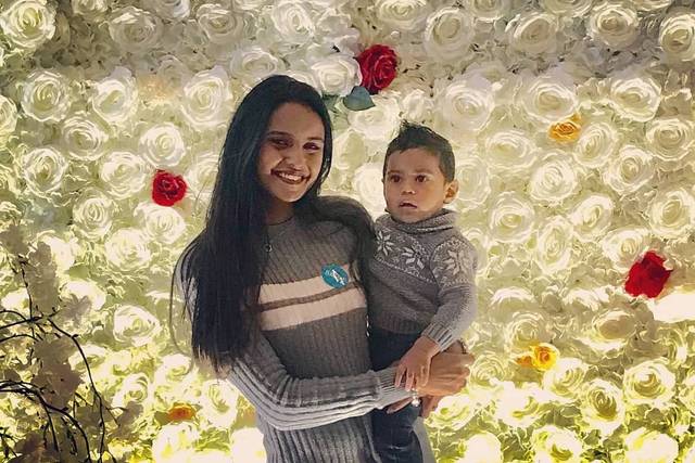 Bride posing with flower wall