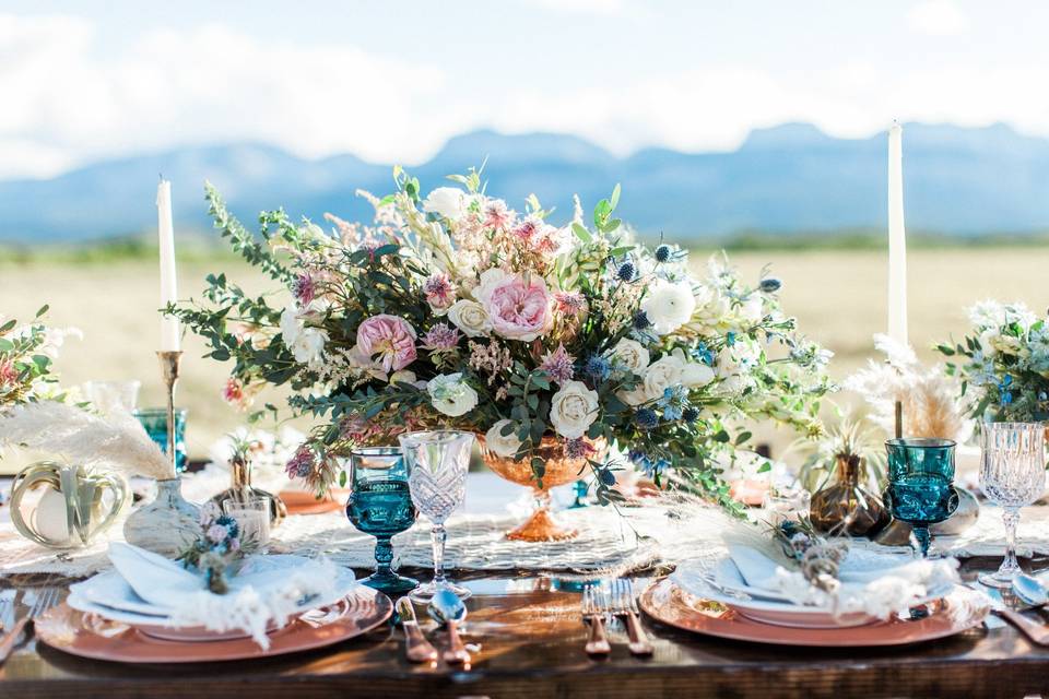 Sweetheart table with floral and candle centerpiece