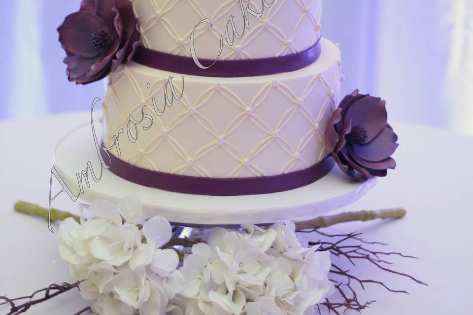 Wedding cake with violet ribbons