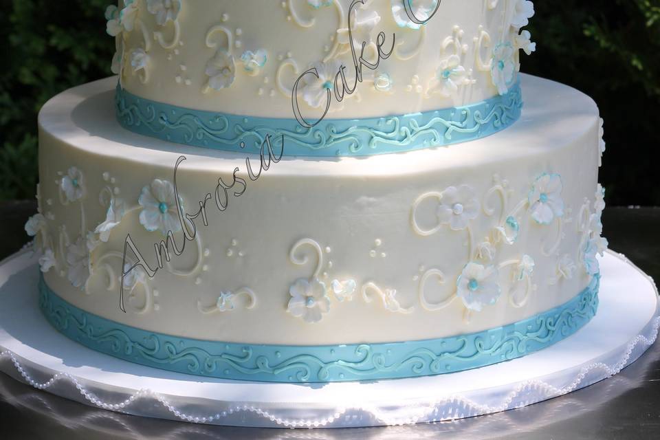 3-tier cake with blue ribbons