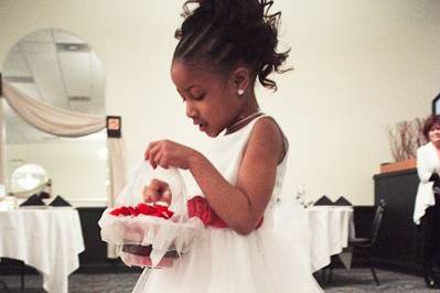 a flower girl walks the aisle, spreading petals for the bride to walk on