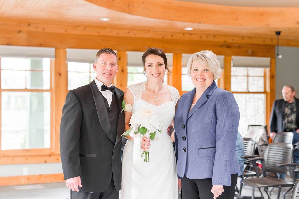 Groom and bride with the officiant