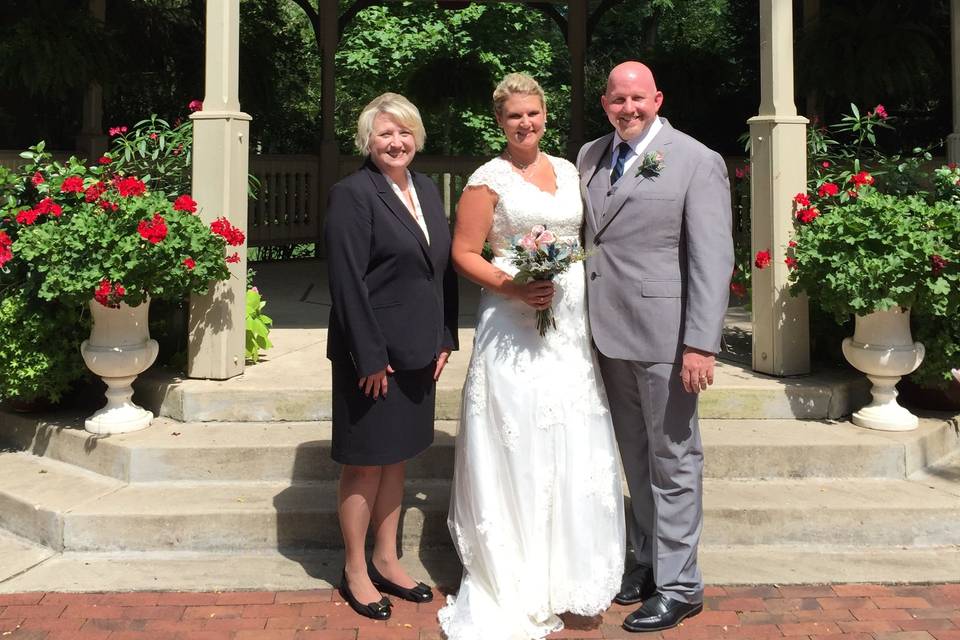 Groom and bride with the officiant