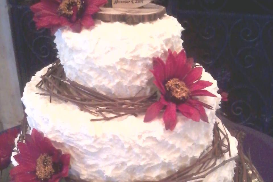 Three Tiered Round Rustic Wedding Cake with Fresh Flowers.