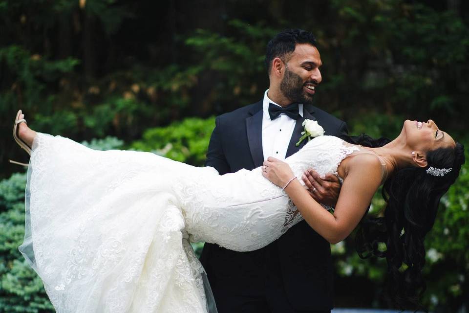 Groom lifting his bride