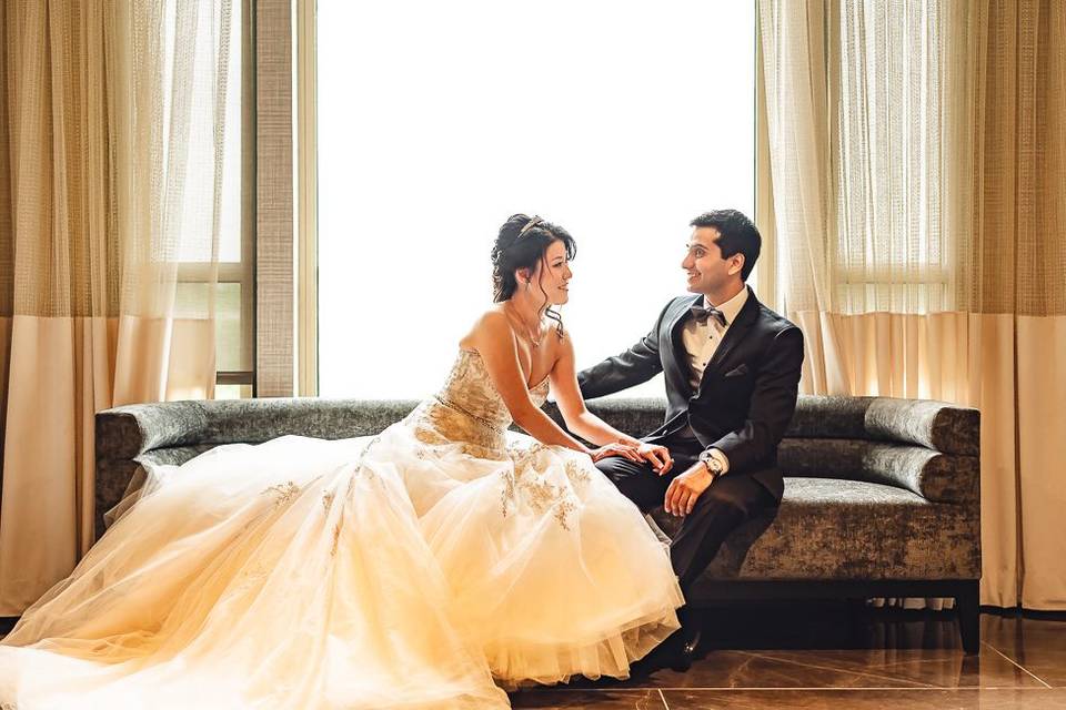 Bride and groom sitting on the lounge sofa