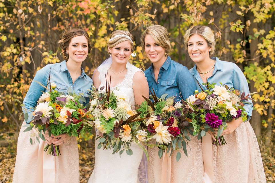 Bridal party with floral arrangements