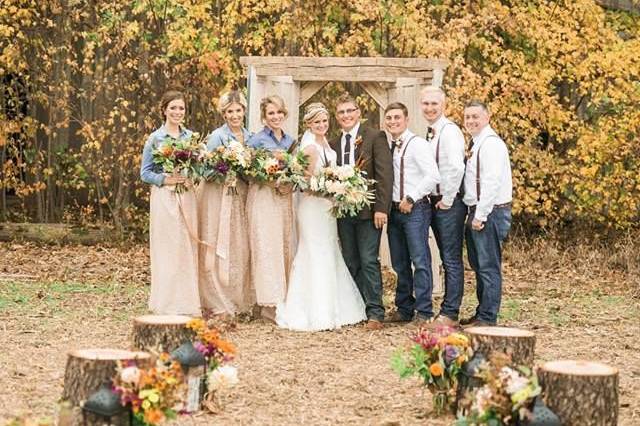Wedding party in view of autumn trees