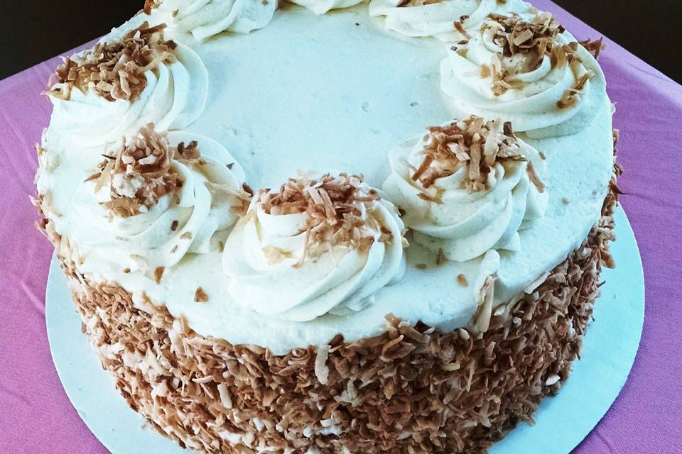 Coconut Cake.  A delicious coconut cake infused with a coconut simple syrup, topped with coconut buttercream and toasted coconut.  A coconut lover's dream