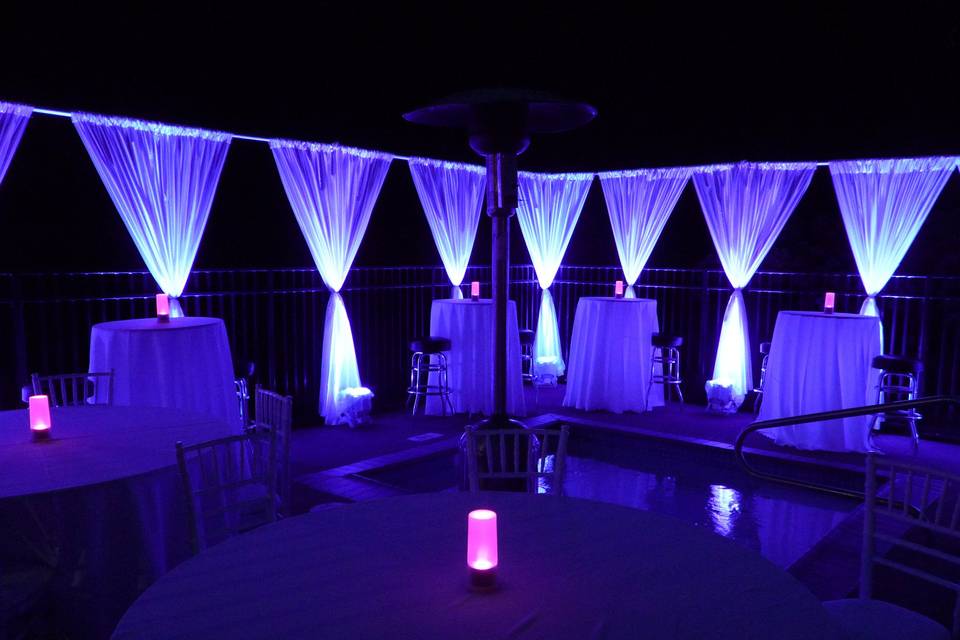 Don't let your outdoor event disappear in the night!  The decorator used standard pipe-and-drape to give us a lovely perimeter to uplight, and we filled it in with under-table glow and our wireless tabletop lanterns.