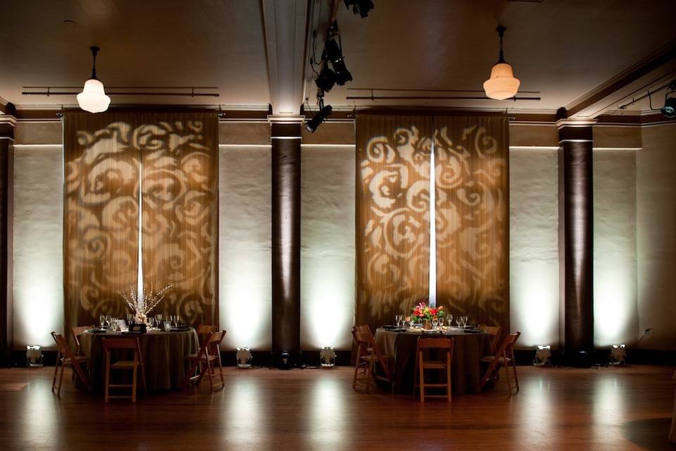 A soft, vintage feel with this pattern projection, which was precisely cropped to fit the curtains between ivory uplighting.