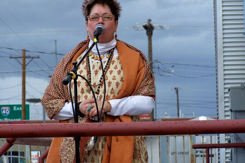 Rev. Gwen, representing the Hindu tradition, at a political action in downtown ABQ with many other ministers of various faith traditions.