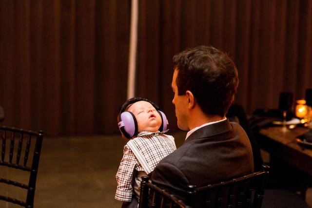 Baby with ear muffs