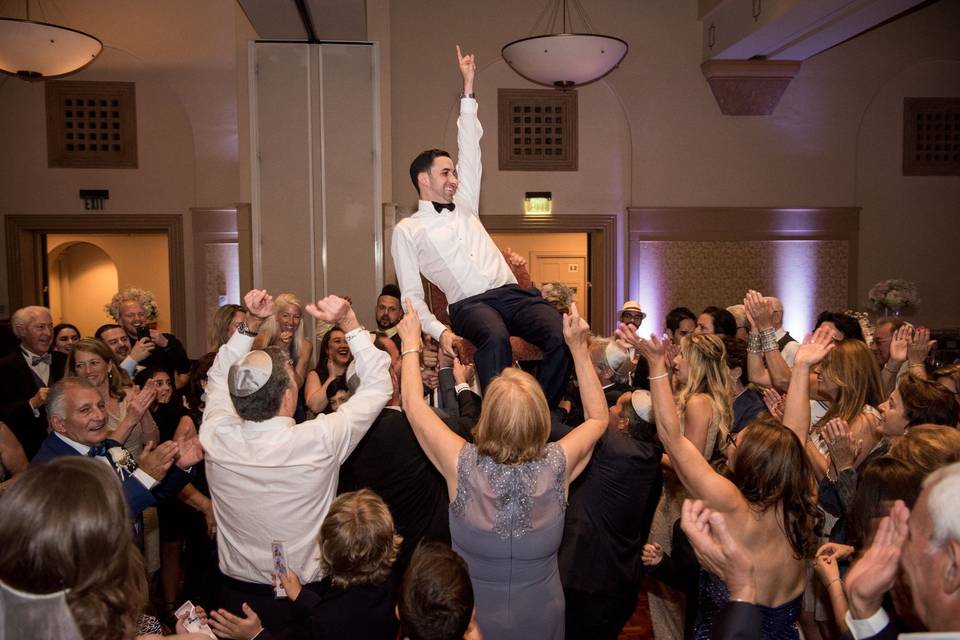 Groom carried by the crowd