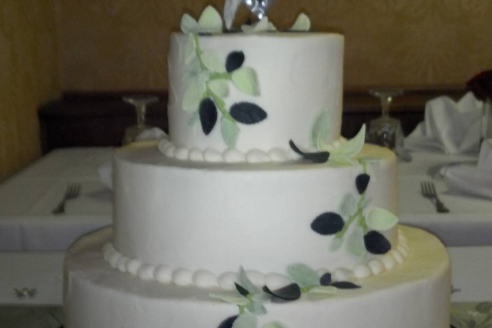 3 tier wedding cake delivered to Port Townsend's Manresa Castle.  Buttercream iced with fondant leaves in several green shades.