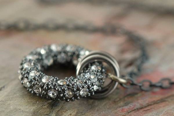 This necklace features a 14mm round Gunmetal, pave crystal set 
