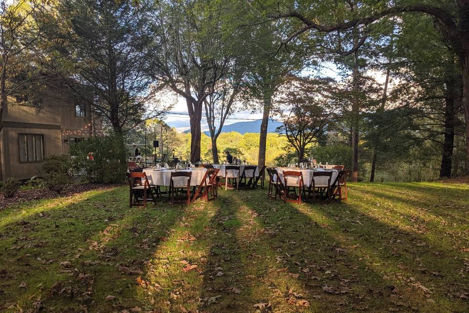 Rehearsal dinner with the sunlight shining through trees