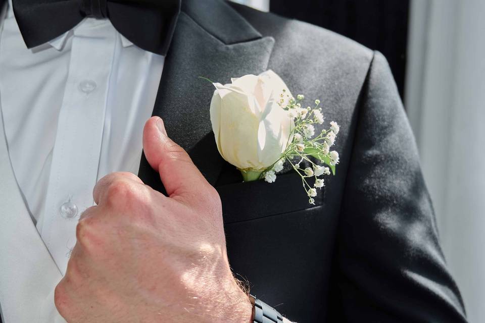 Close of Groom with White Rose