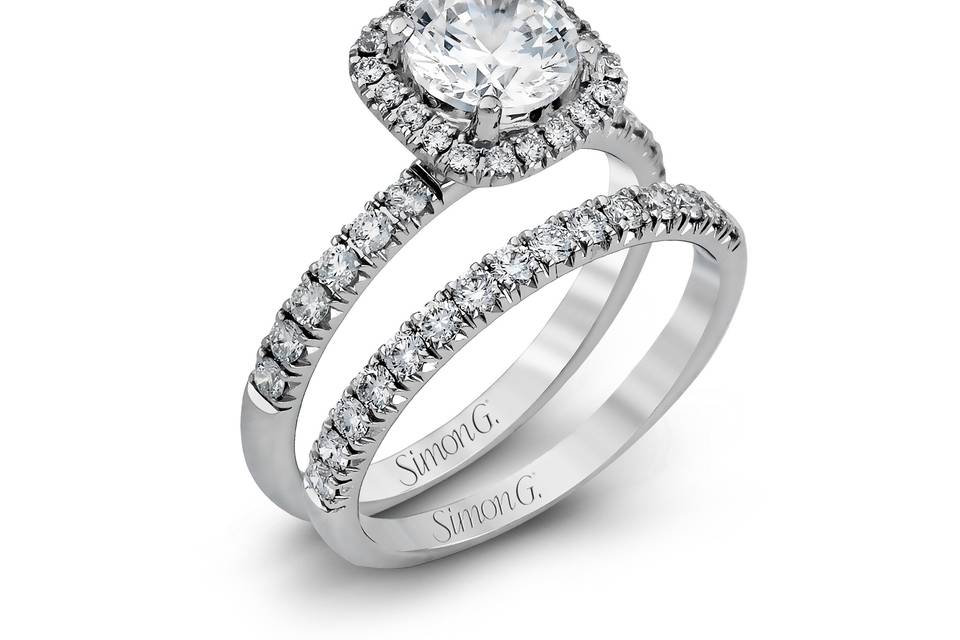 Style MR2132 <br> This elegant classic white gold halo engagement ring and band is set with .78 ctw of sparkling round cut white diamonds.