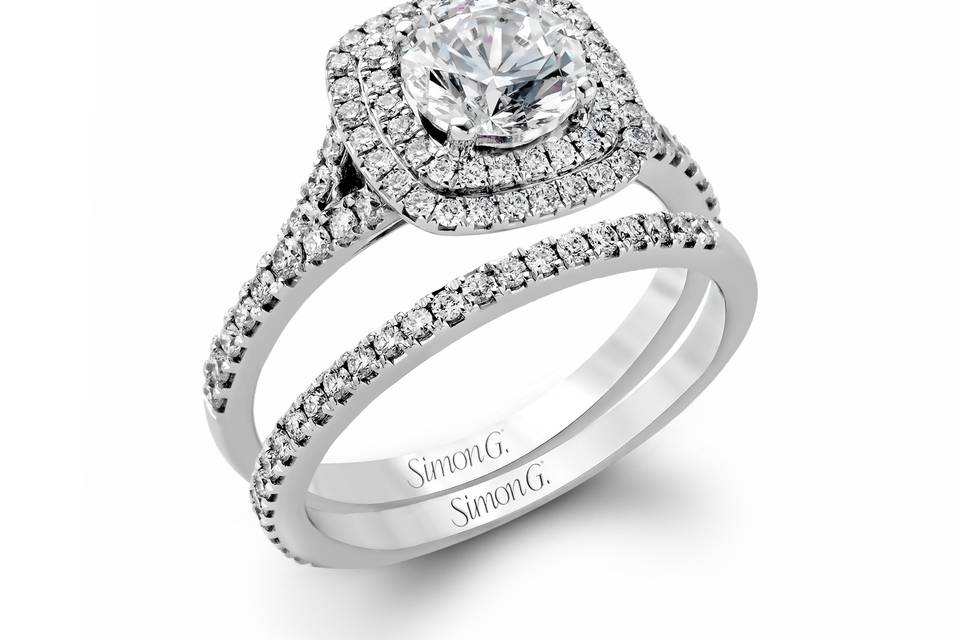 Style MR2459 <br> This eye-catching contemporary white gold engagement ring and wedding band set features an impressive halo accented by .63 ctw round cut white diamonds.