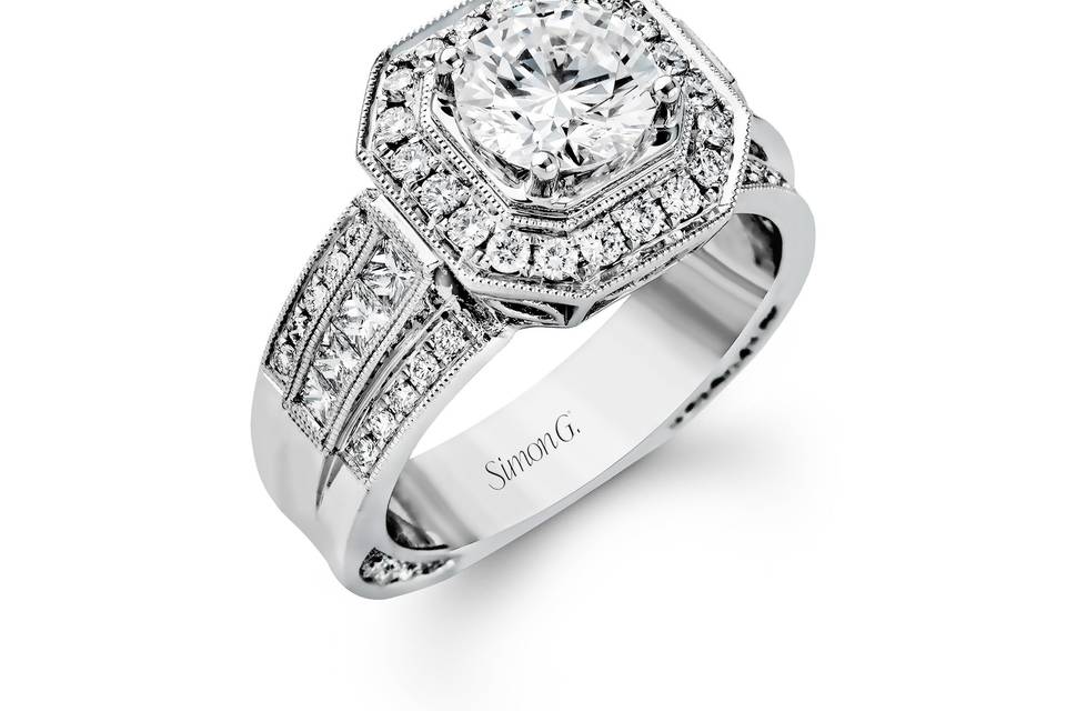 Style NR109 <br> Featuring an impressive modern design, this white gold ring is accented by .60 ctw round cut white diamonds and .40 ctw princess cut diamonds.