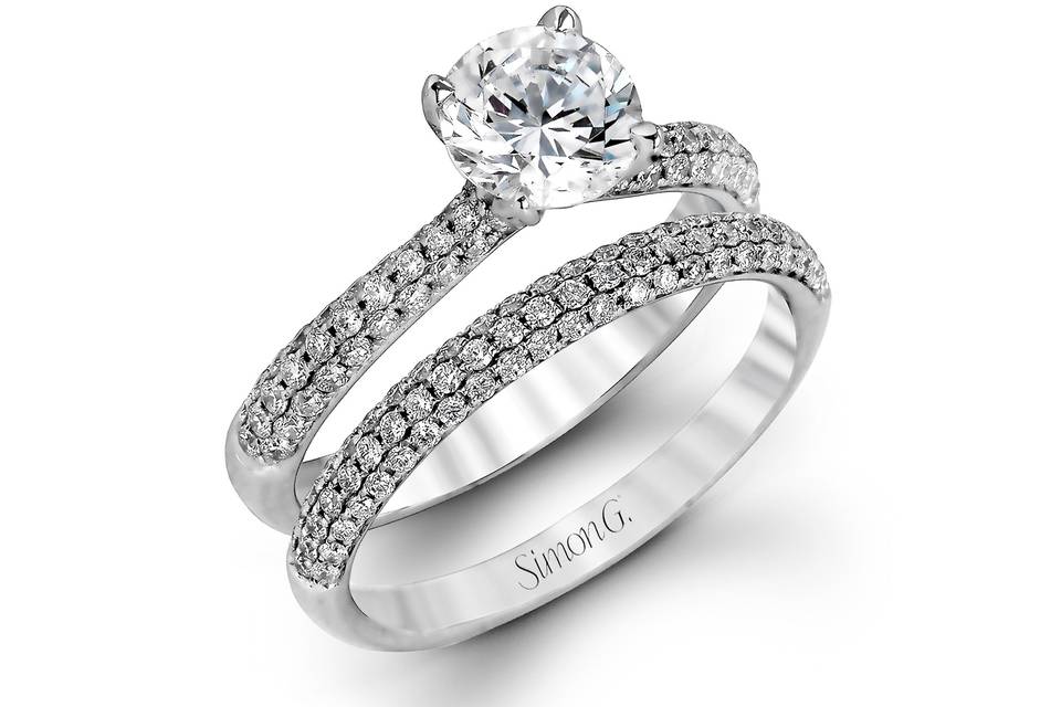 Style TR431 <br> The classic design of this white gold engagement ring and wedding band set is emphasized by .72 ctw round cut white diamonds.
