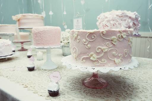 Deconstructed wedding cake table featuring flowers, leaves and vines design (front), Cornelli lace (left), and meringue icing (back right)