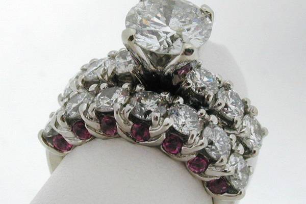 Heavy hand carved twisted common prong engagement ring and matching band with round brilliant diamonds and pink tourmaline accents.  Tulip style head with 2.50 ct round brilliant diamond.