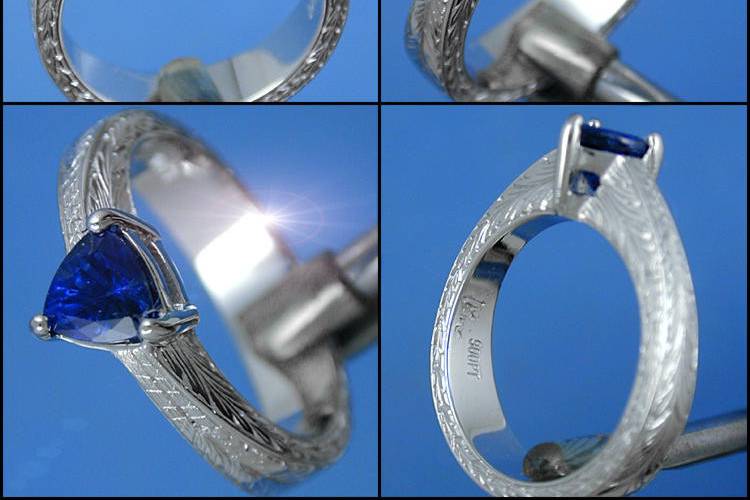 Hand Carved Solitaire in Platinum with hand engraving for a trillion cut blue sapphire.  Available for any size, shape or material of center stone, with a multitude of hand engraving options, custom to you.