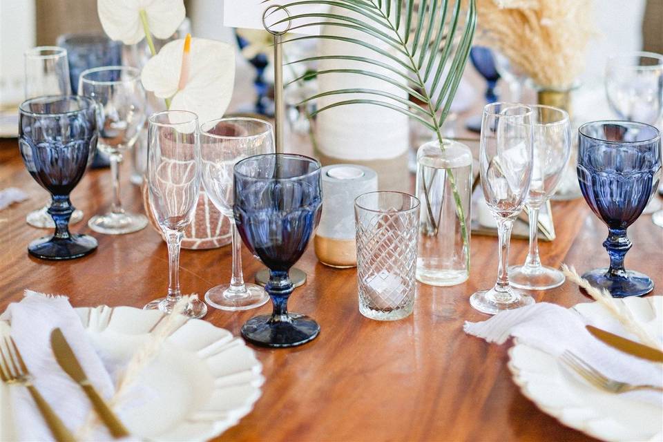 Greenery stems and blue glassware