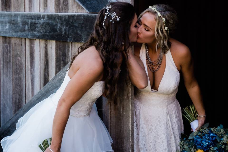 Couple kiss around barn door